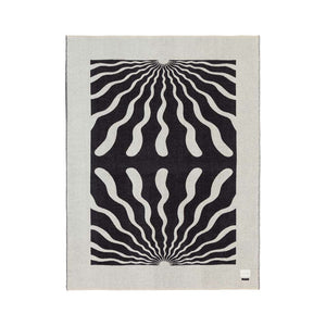 The Blacksaw Dopamine Psychedelic Art Blanket in Black/Ivory Flat laying product shot