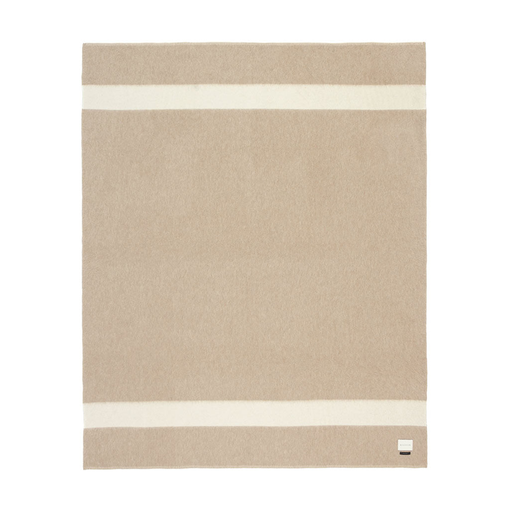 The Blacksaw 100% Recycled Siempre Blanket  laying flat in Beige with Ivory Stripe