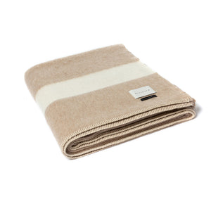 The Blacksaw 100% Recycled Siempre Blanket in Beige with Ivory Stripe, folded product shot with beautiful Blanket Stitching and branded label