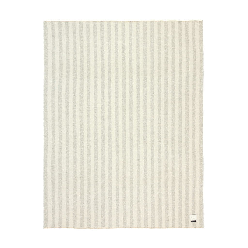 The Blacksaw Stills Vertical Stripe Blanket in Light heather Grey/Ivory Flat laying product shot
