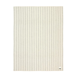 The Blacksaw Stills Vertical Stripe Blanket in Light heather Grey/Ivory Flat laying product shot