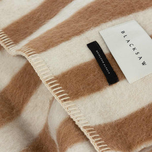 The Blacksaw Stills Vertical Stripe Blanket in Tabacco Brown Close Up product shot showing beautiful Blacksaw brand label, Heirloom Alpaca label and Blanket Stitching detail