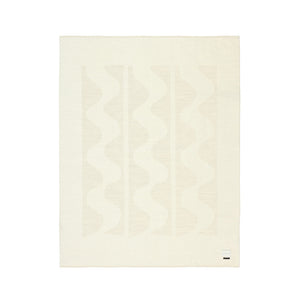 The Blacksaw 100% Alpaca, Reversible TimeWarp Throw Blanket laying flat in Zero Dye Ivory & Shoji.