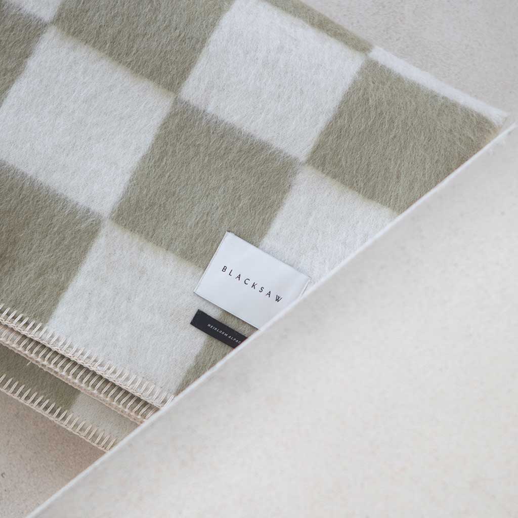 The Blacksaw Checkerboard Crosby Blanket in Boa Green, Flat laying product shot