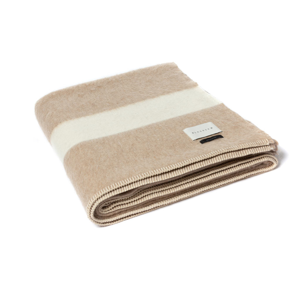 The Blacksaw 100% Recycled Siempre Blanket  laying flat in Beige with Ivory Stripe