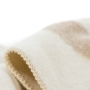 The Blacksaw  100% Recycled Siempre Blanket Blanket in  Ivory with Beige Stripe Close Up product shot showing beautiful brand label and Blanket Stitching detail