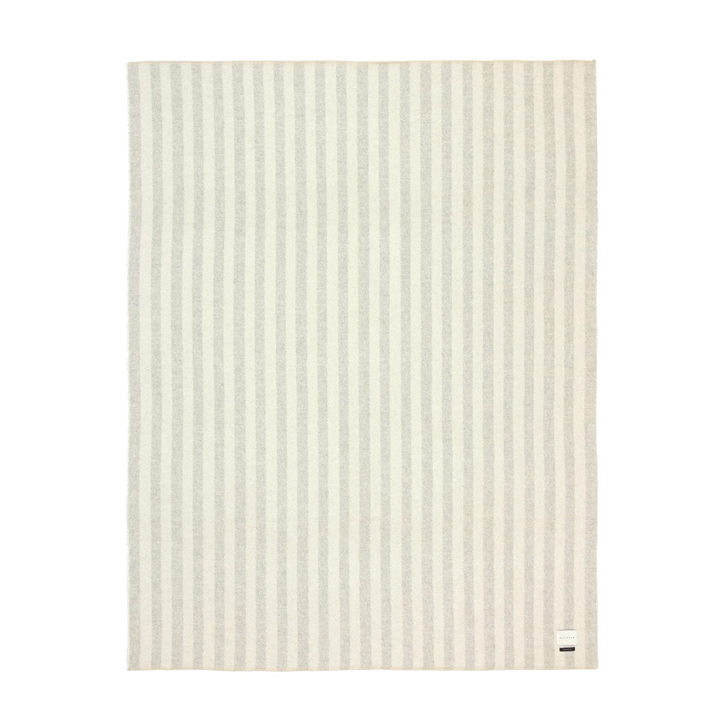 The Blacksaw Stills Vertical Stripe Blanket in Light heather Grey/Ivory Flat laying product shot