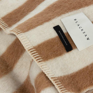 The Blacksaw Stills Vertical Stripe Blanket in Tabacco Brown Close Up product shot showing beautiful Blacksaw brand label, Heirloom Alpaca label and Blanket Stitching detail