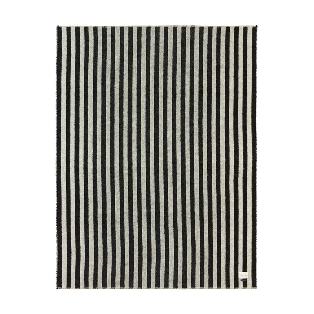 The Blacksaw Stills Vertical Stripe Blanket in Black/Ivory Flat laying product shot