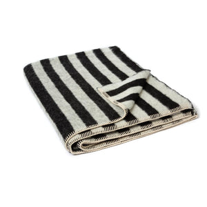 The Blacksaw Stills Vertical Stripe Blanket in Black/Ivory Colour folded product shot with beautiful Blanket Stitching