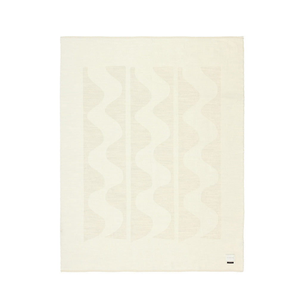 The Blacksaw 100% Alpaca, Reversible TimeWarp Throw Blanket laying flat in Zero Dye Ivory & Shoji. 
