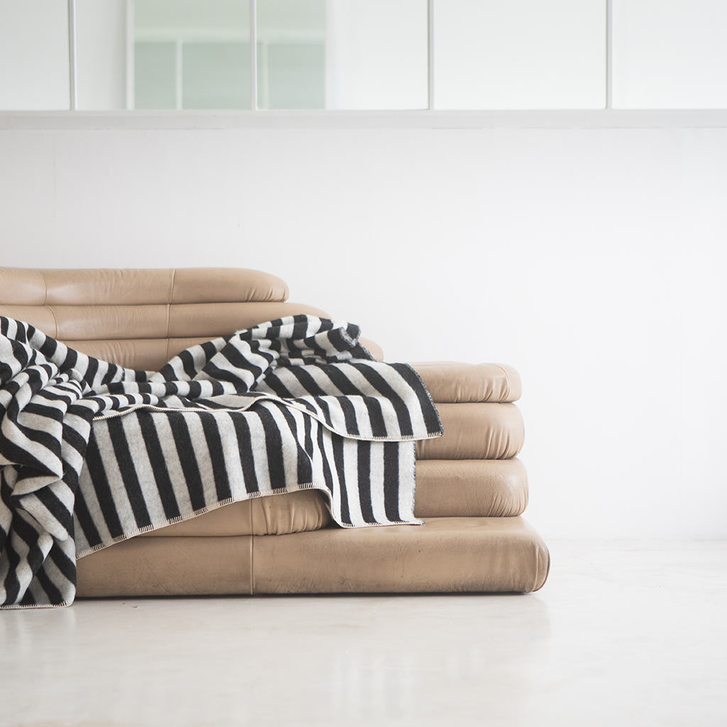 The Blacksaw Stills Vertical Stripe Blanket in Black/Ivory Flat laying product shot